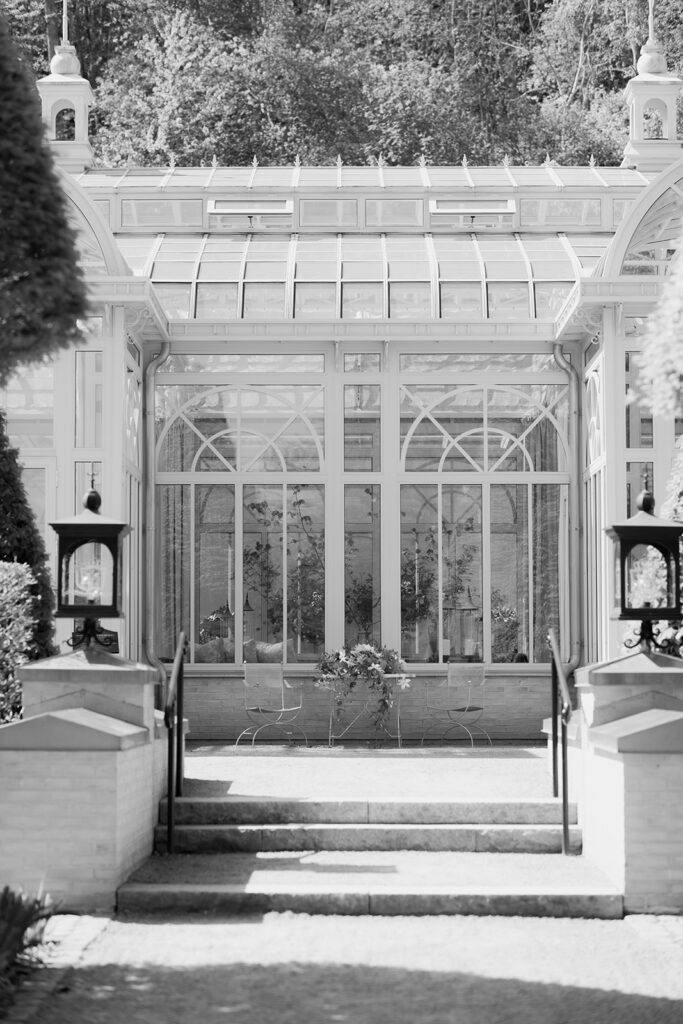 Wedding at Norrvikens trädgårdar 59 Black and white: stone steps leading up to the glass facade of Victoriahuset