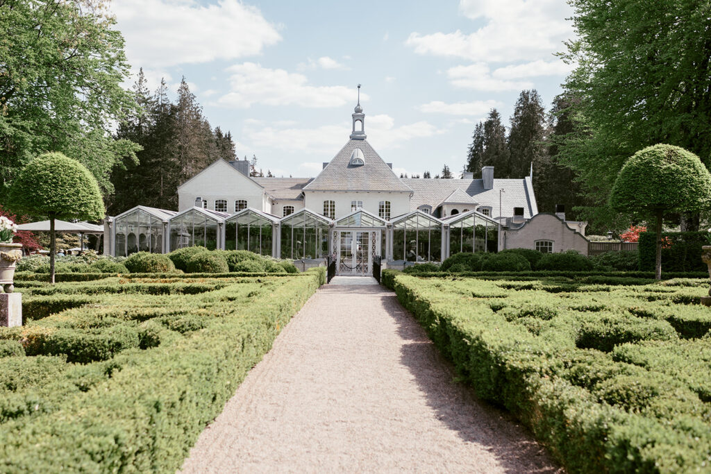 Wedding at Norrvikens trädgårdar 63 Formal parterre with clipped hedges and a gravel path leading to Villa Abelin