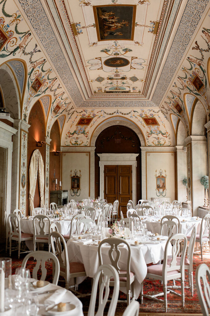 Dinner tables set for a black tie wedding at Rånäs Castle in Sweden