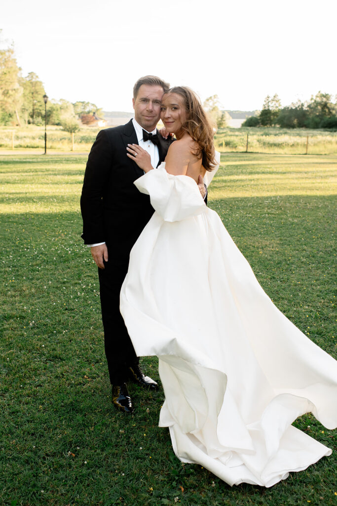 Groom in a tuxedo and bride in a flowing gown at a black tie wedding at Rånäs Castle
