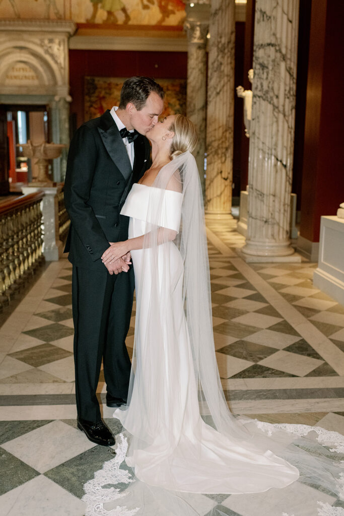 Black tie wedding kiss in the marble hall of Nationalmuseum Stockholm