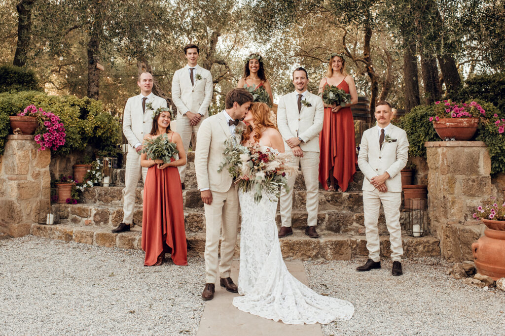 Bridal party in colorful dresses under olive trees, Tuscan wedding