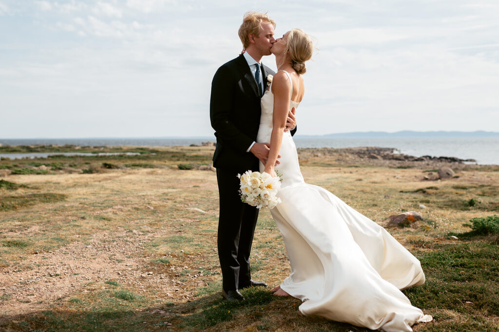 Getting married in Sweden: paperwork and planning 8 Brudpar som kysser varandra vid havet med vinden i klänningen