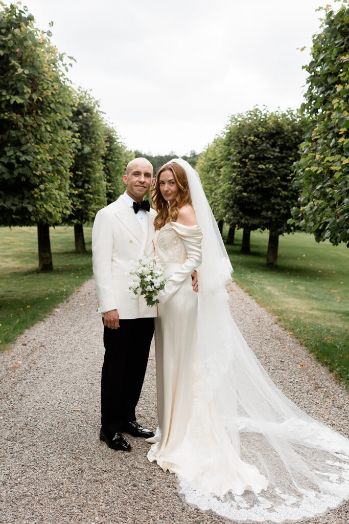 Wedding at Jordberga: a photographer's guide 8 Couple standing together on a tree lined path