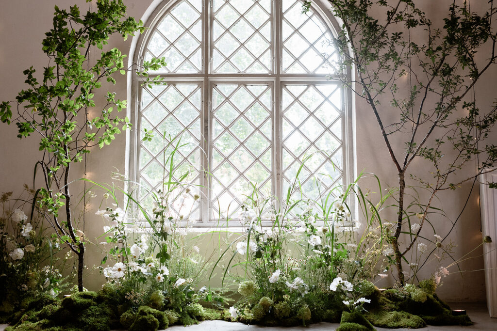 Wedding at Jordberga: a photographer's guide 11 Leaded window framed by climbing greenery and white flowers