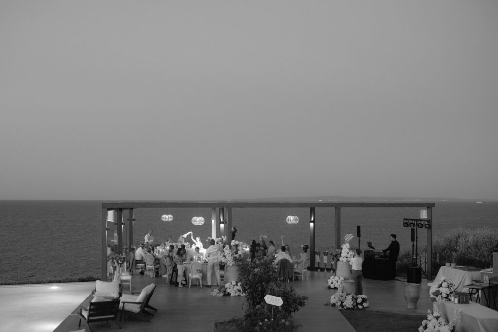 Soft black and white photograph of guests at the wedding reception