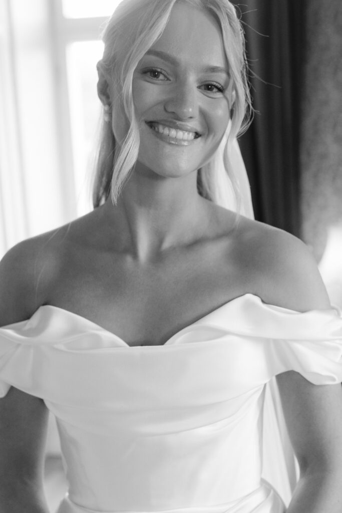 Wedding at Thorskogs Slott 30 Black and white: the bride smiling at the camera in her wedding dress
