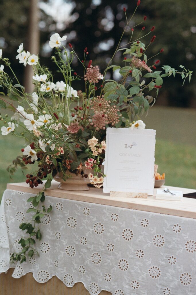 Wildflowers and a sign on a table with a lace cloth, shot on 35mm film