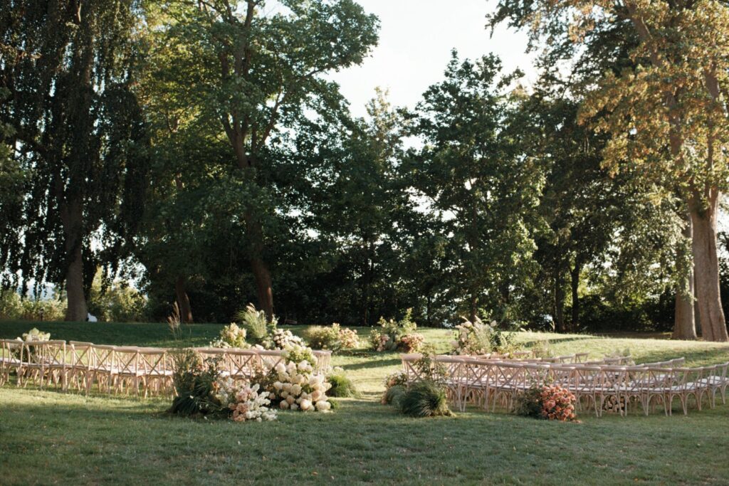 The ceremony space in the park with chairs in a half circle and flowers between the rows, shot on 35mm film