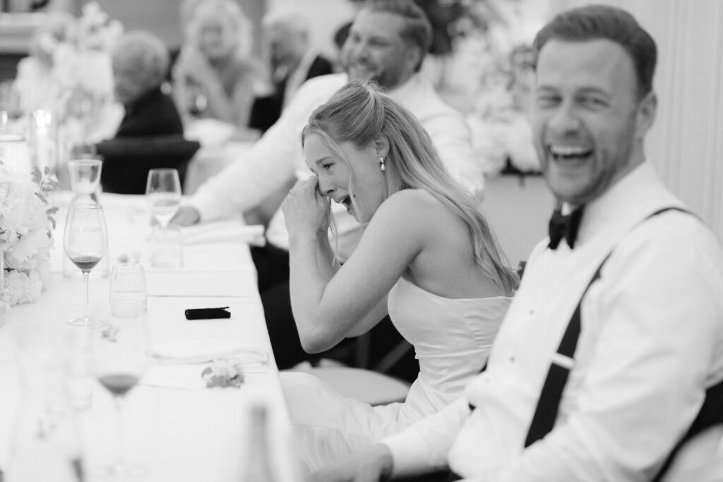 Wedding at Norrvikens trädgårdar 23 Black and white: the couple laughing at the dinner table